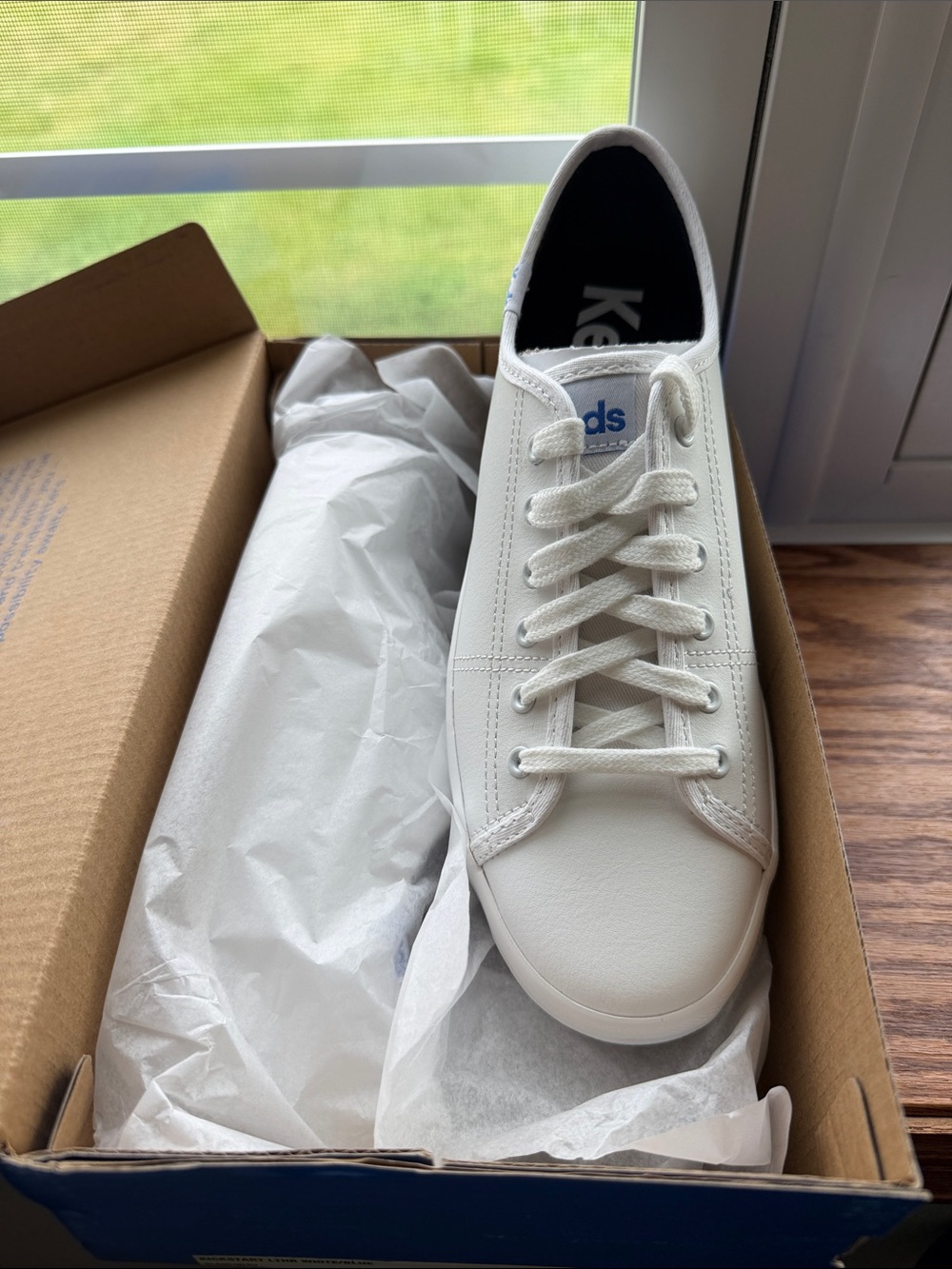 Keds White Low-Top Sneaker with Subtle Blue Logo